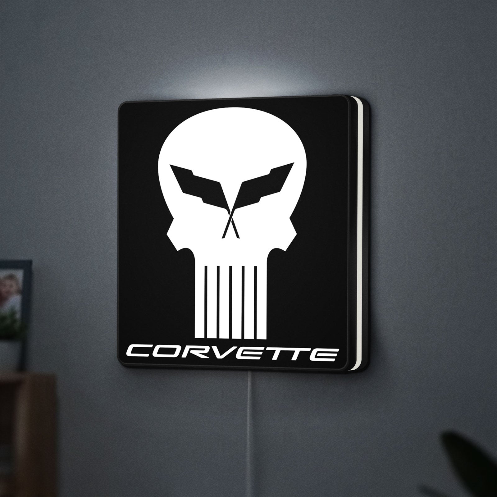Corvette Skull LED lightbox hanging on a wall with white glow