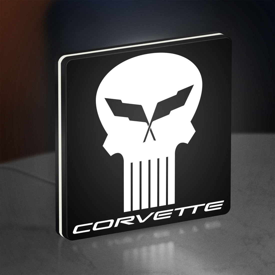 Corvette Skull LED lightbox hanging on a wall with white glow