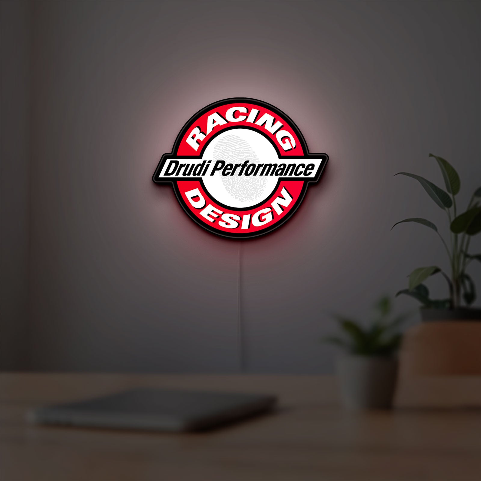 Drudi Performance LED lightbox hanging on a room wall with soft red light