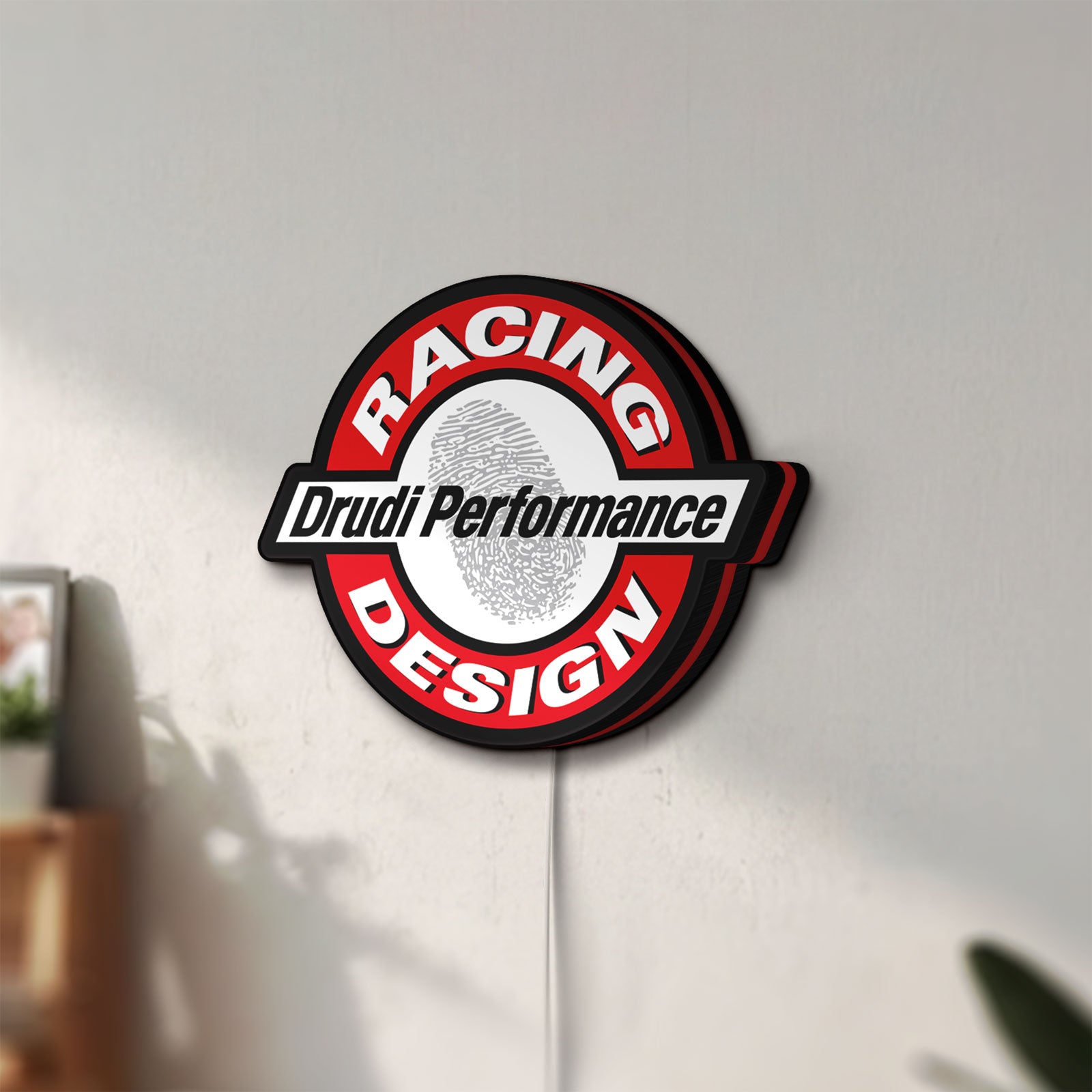 Unlit Drudi Performance LED lightbox mounted on a wall in daylight