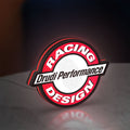 Drudi Performance LED lightbox standing on a desk from an angled side view with red glow