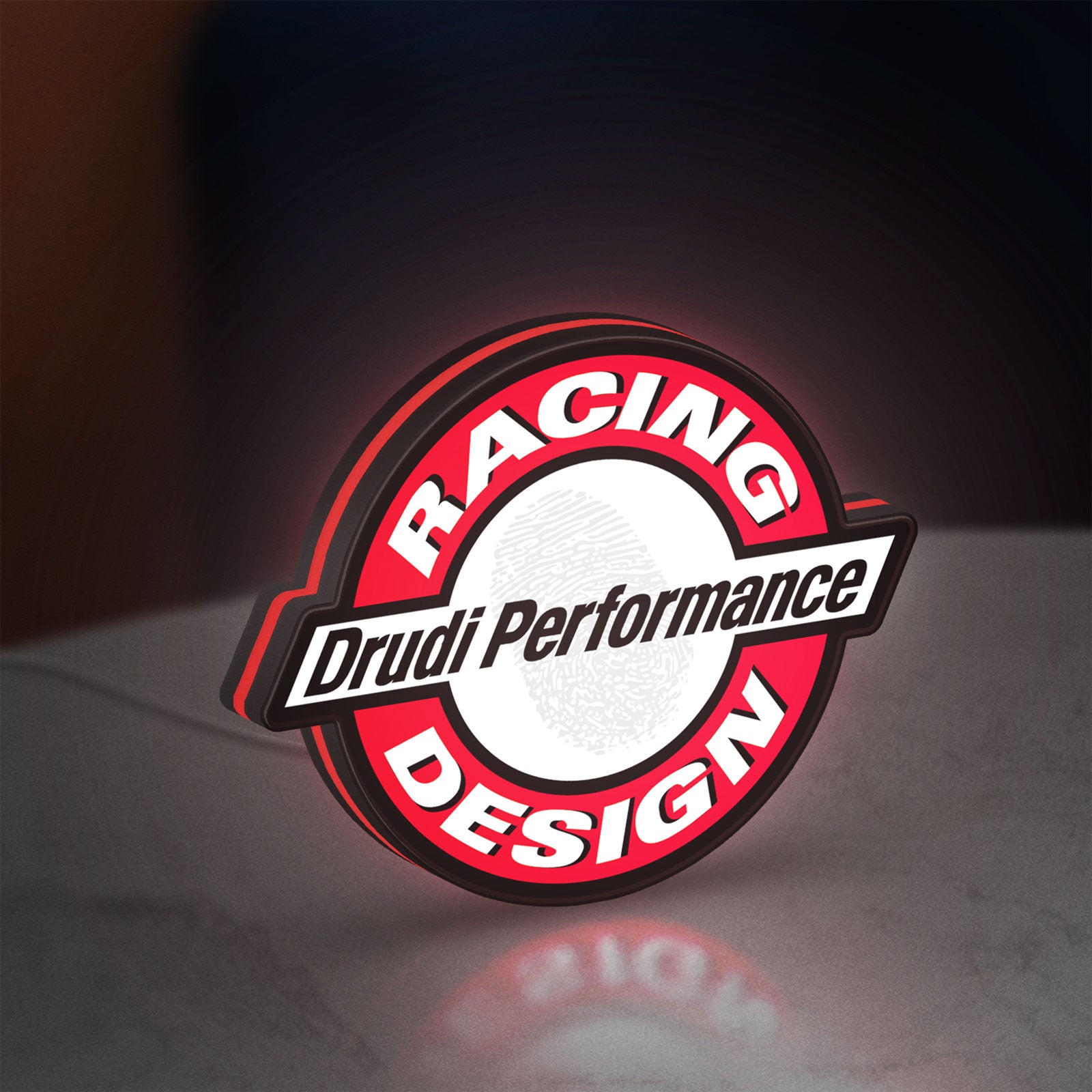 Drudi Performance LED lightbox standing on a desk from an angled side view with red glow