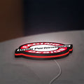 Drudi Performance LED lightbox lying flat on a desk with red glow