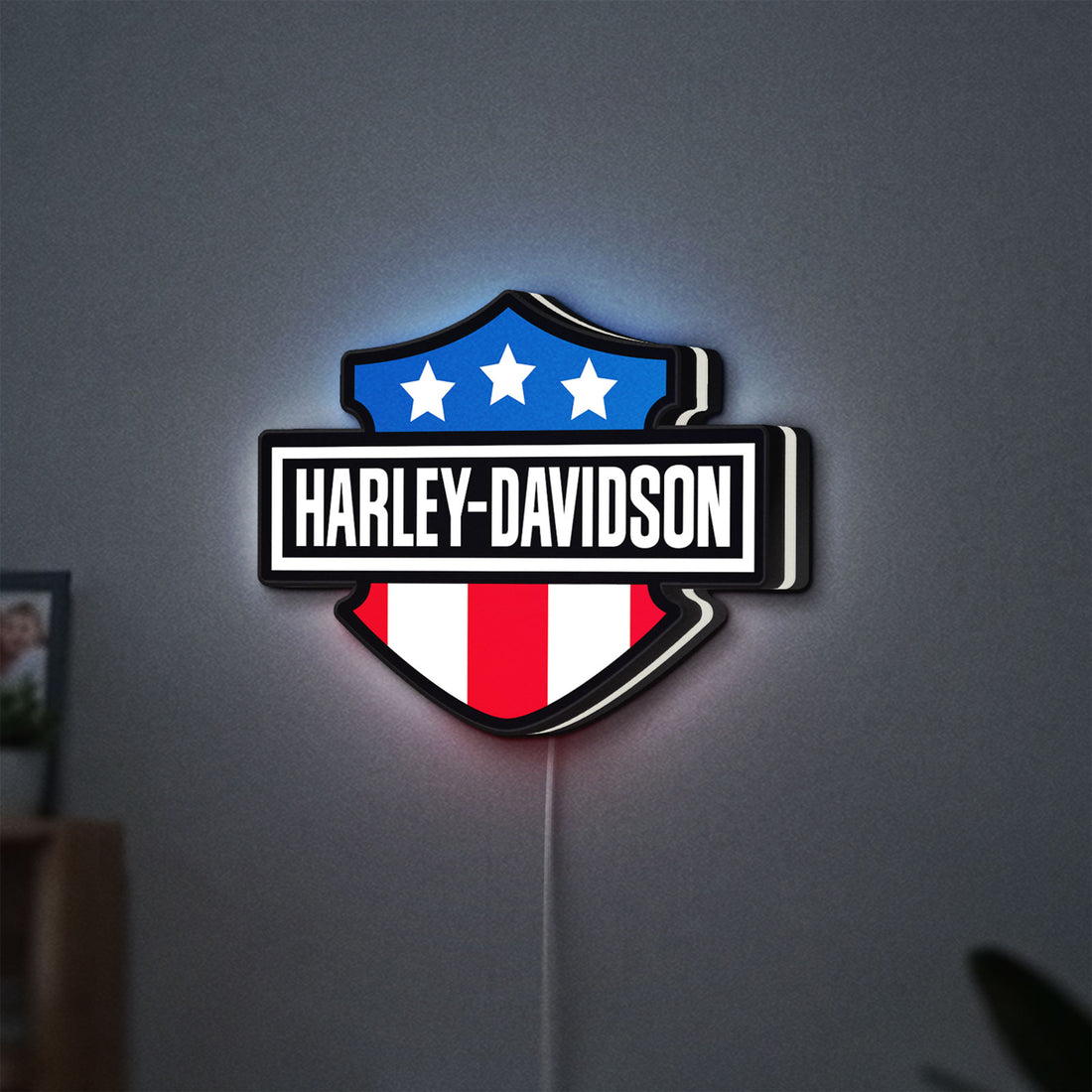 Harley Shield Motorcycle LED lightbox hanging on a wall with white glow