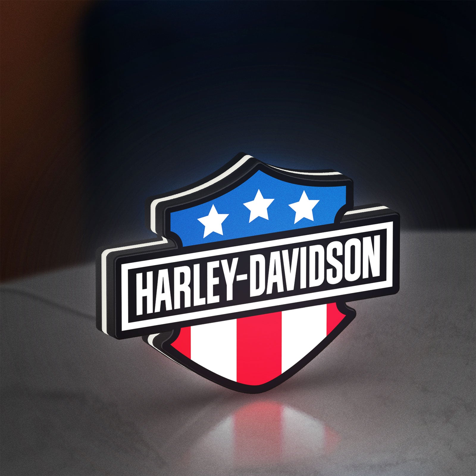 Harley Shield Motorcycle LED lightbox standing on a desk from an angled side view with white glow