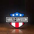 Front view of Harley Shield Motorcycle LED lightbox sign glowing on a wooden desk