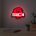 Sidi Cycling LED lightbox hanging on a room wall with soft red light