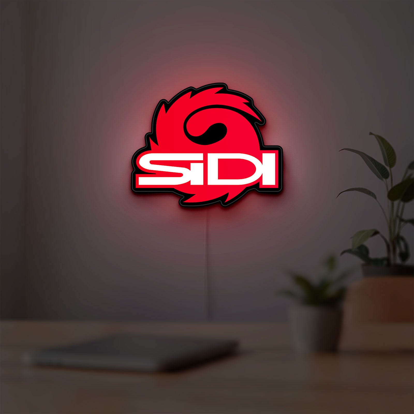 Sidi Cycling LED lightbox hanging on a room wall with soft red light
