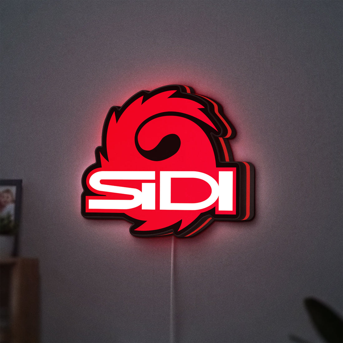 Sidi Cycling LED lightbox hanging on a wall with red glow