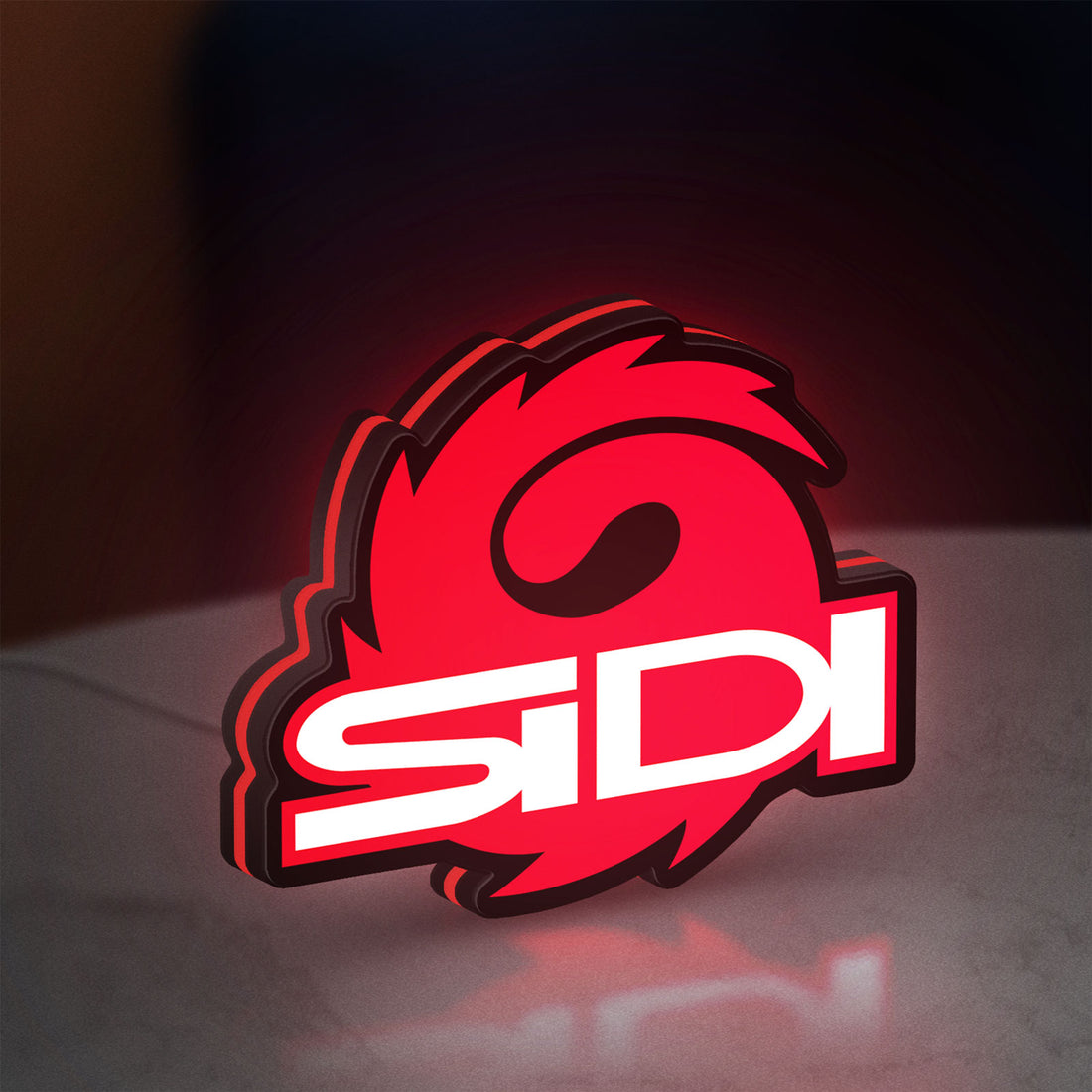Sidi Cycling LED lightbox hanging on a wall with red glow
