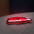 Sidi Cycling LED lightbox lying flat on a desk with red glow
