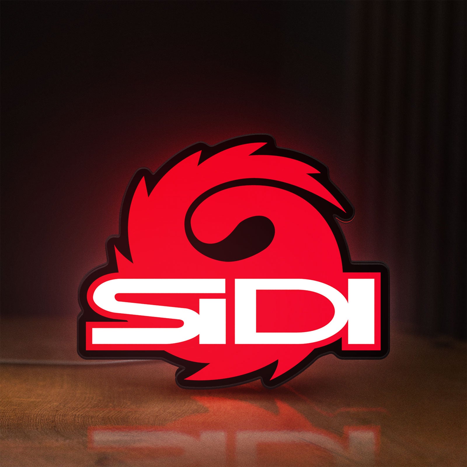 Front view of Sidi Cycling LED lightbox sign glowing on a wooden desk