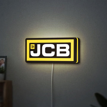JCB Heavy Equipment LED lightbox hanging on a wall with yellow glow