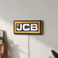 Unlit JCB Heavy Equipment LED lightbox mounted on a wall in daylight