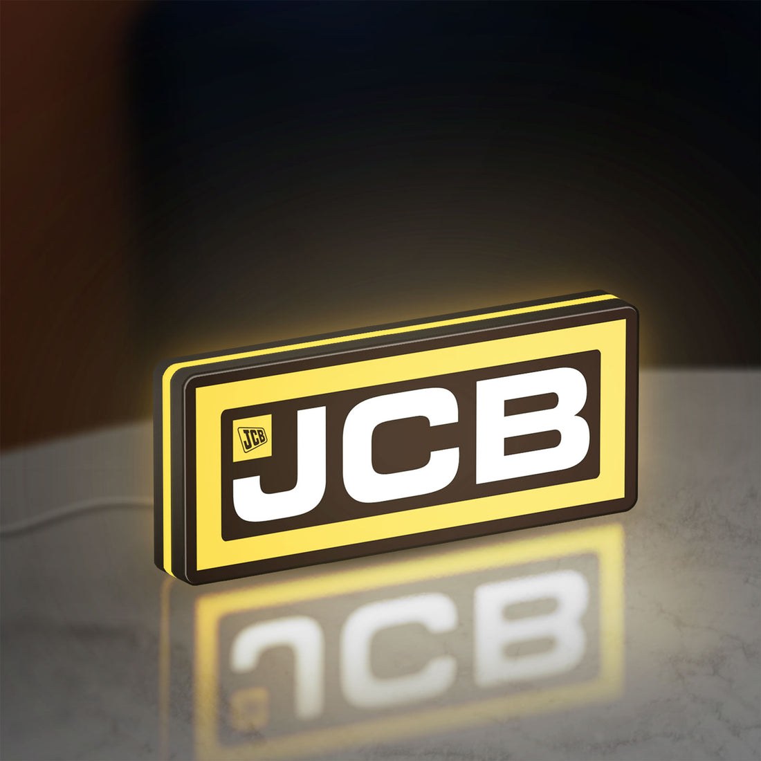 JCB Heavy Equipment LED lightbox hanging on a wall with yellow glow