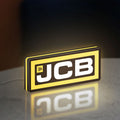 JCB Heavy Equipment LED lightbox standing on a desk from an angled side view with yellow glow