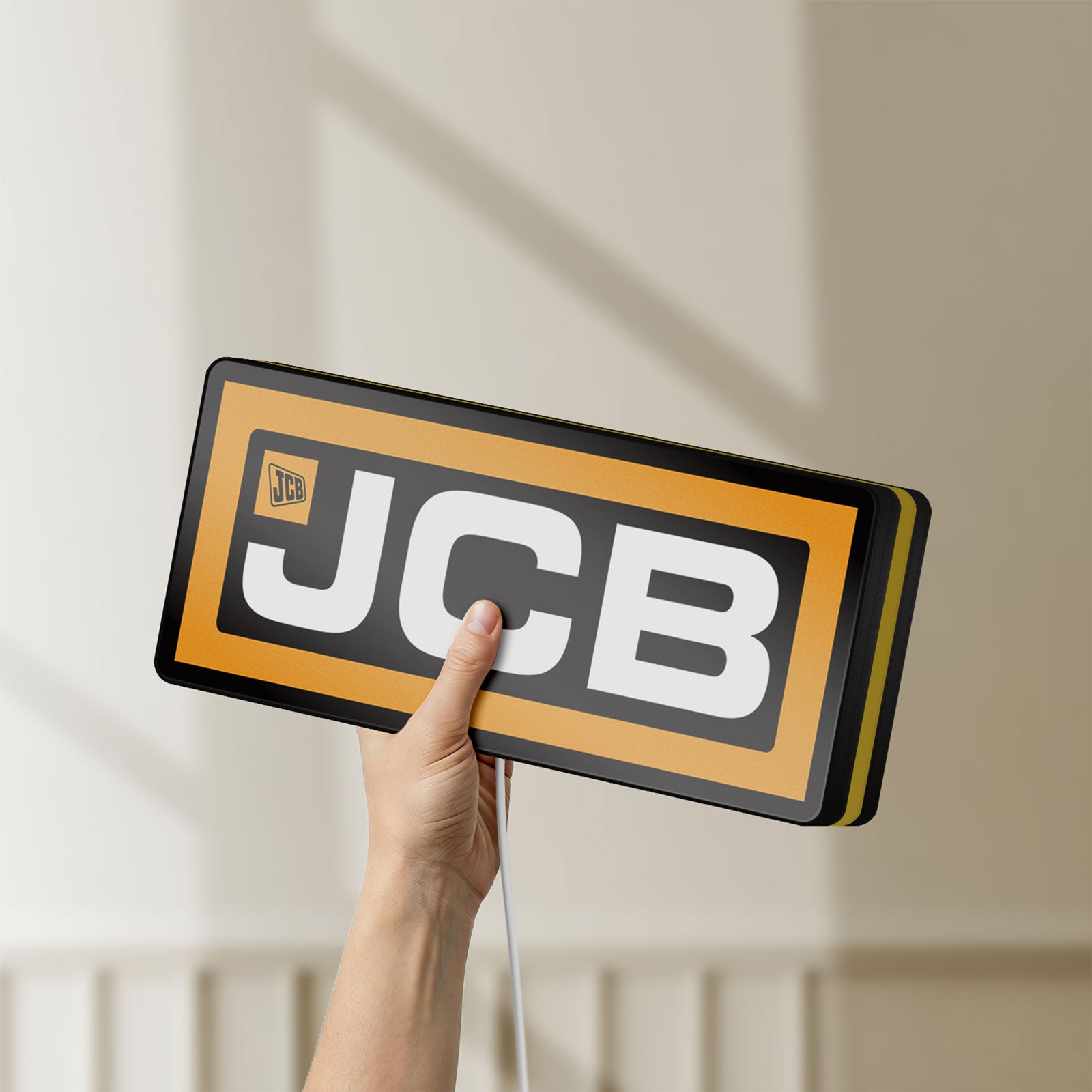 Unlit JCB Heavy Equipment LED lightbox held by hand to show size and details