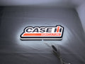 Case Ih Agriculture LED Sign (30cm) - Illuminated flat lay angled view, unique wall art for desk and room decor