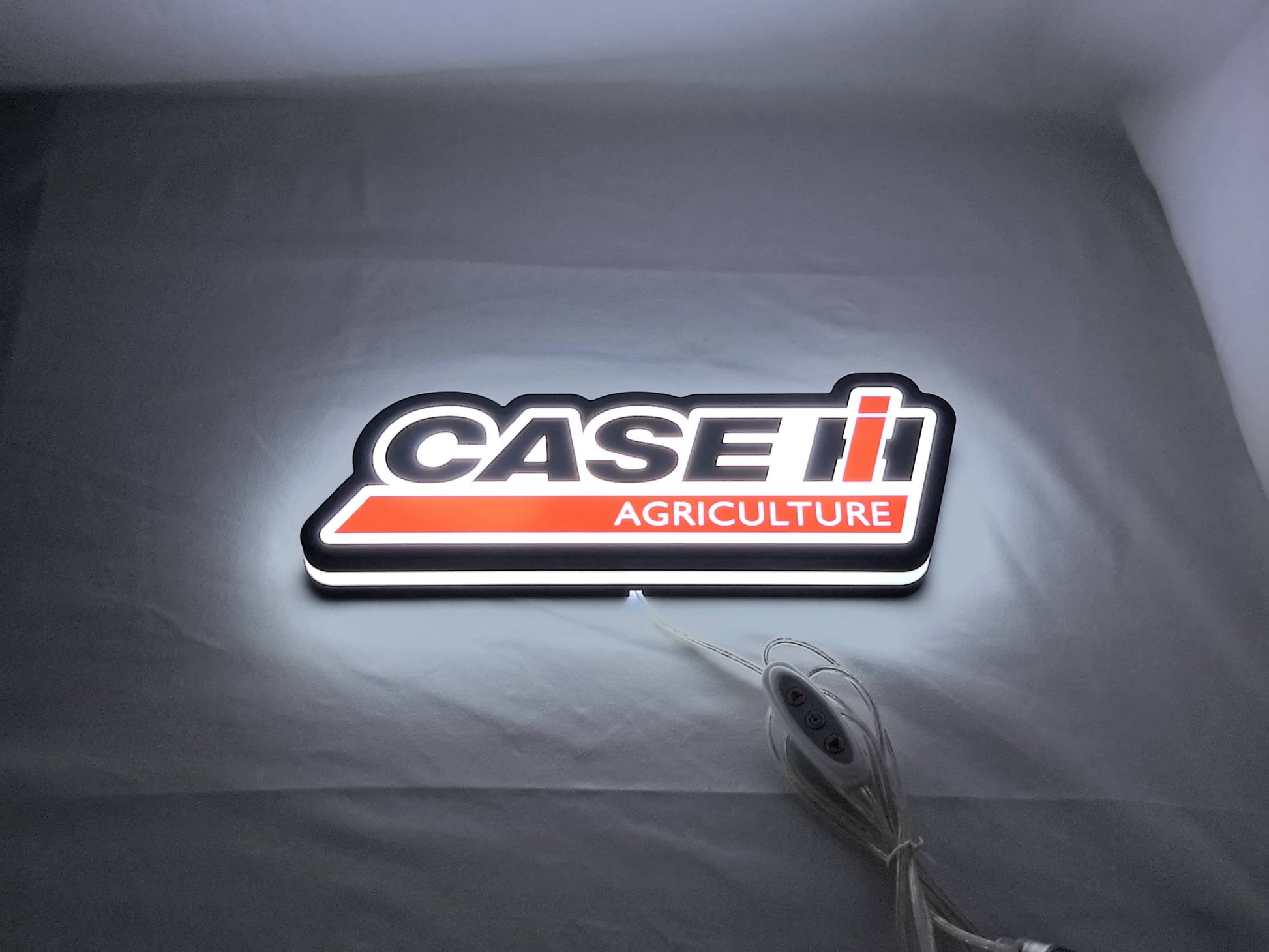Case Ih Agriculture LED Sign (30cm) - Illuminated flat lay angled view, unique wall art for desk and room decor