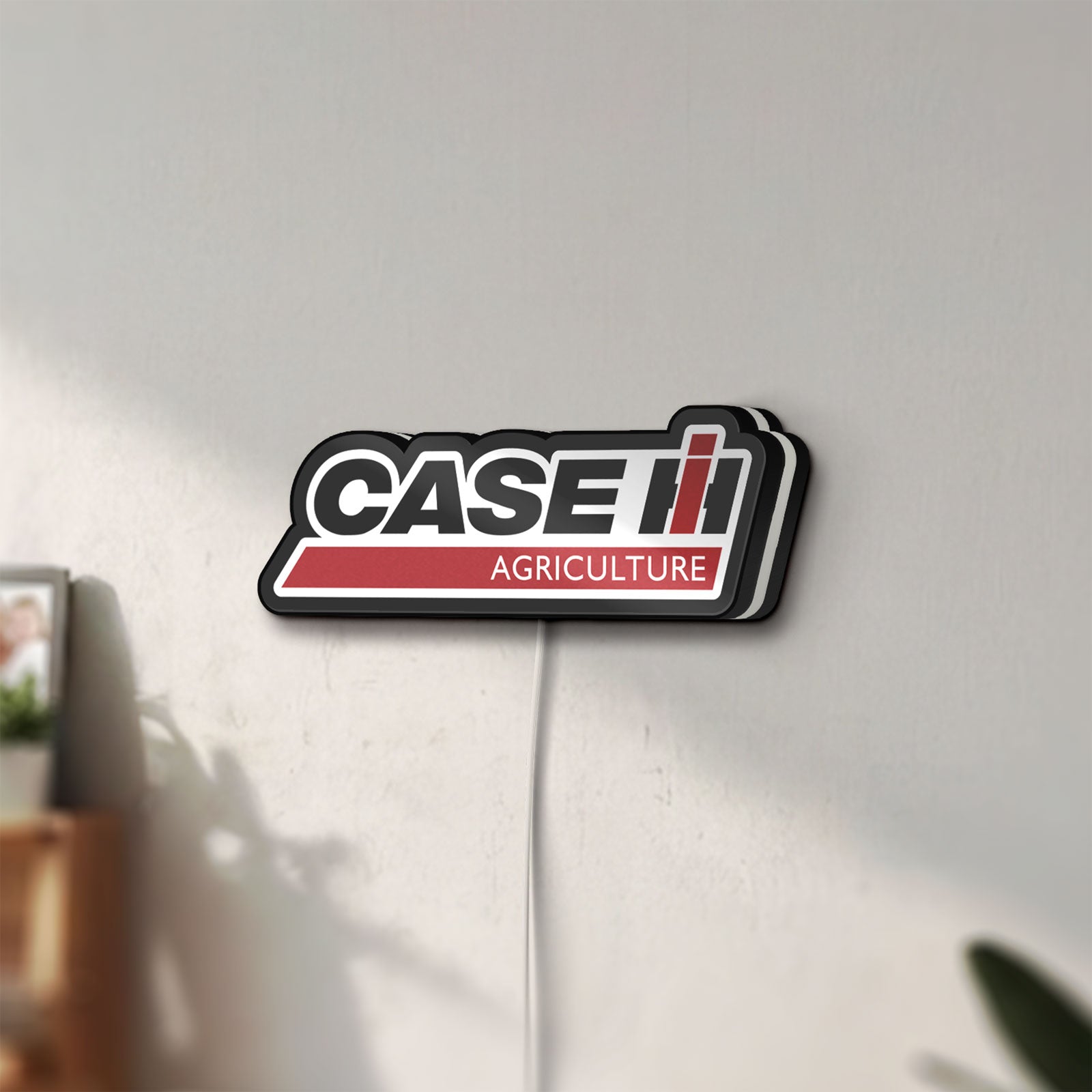 Unlit Case IH Agriculture LED lightbox mounted on a wall in daylight