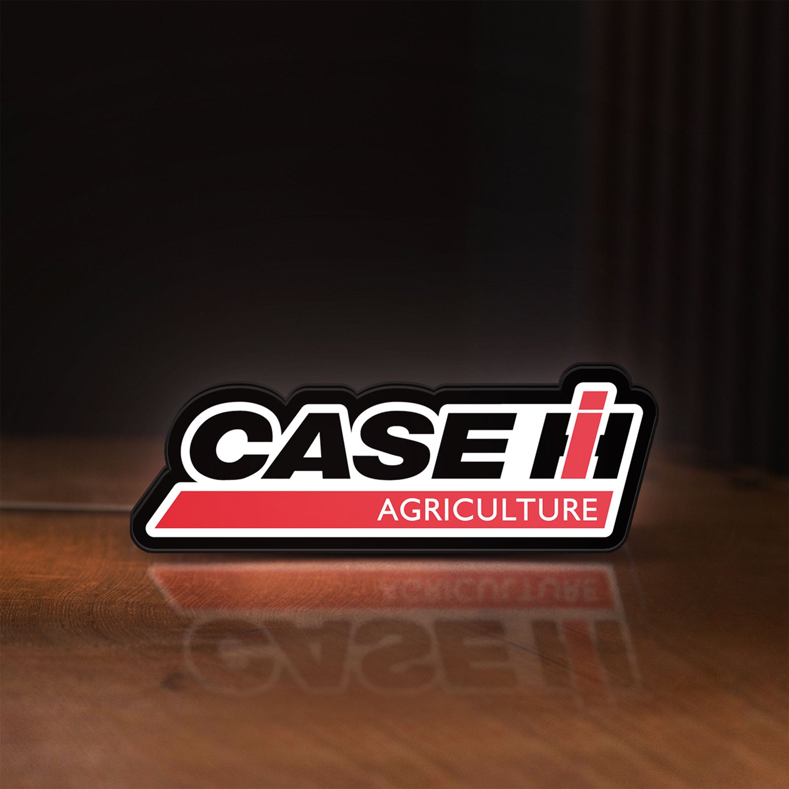Front view of Case IH Agriculture LED lightbox sign glowing on a wooden desk
