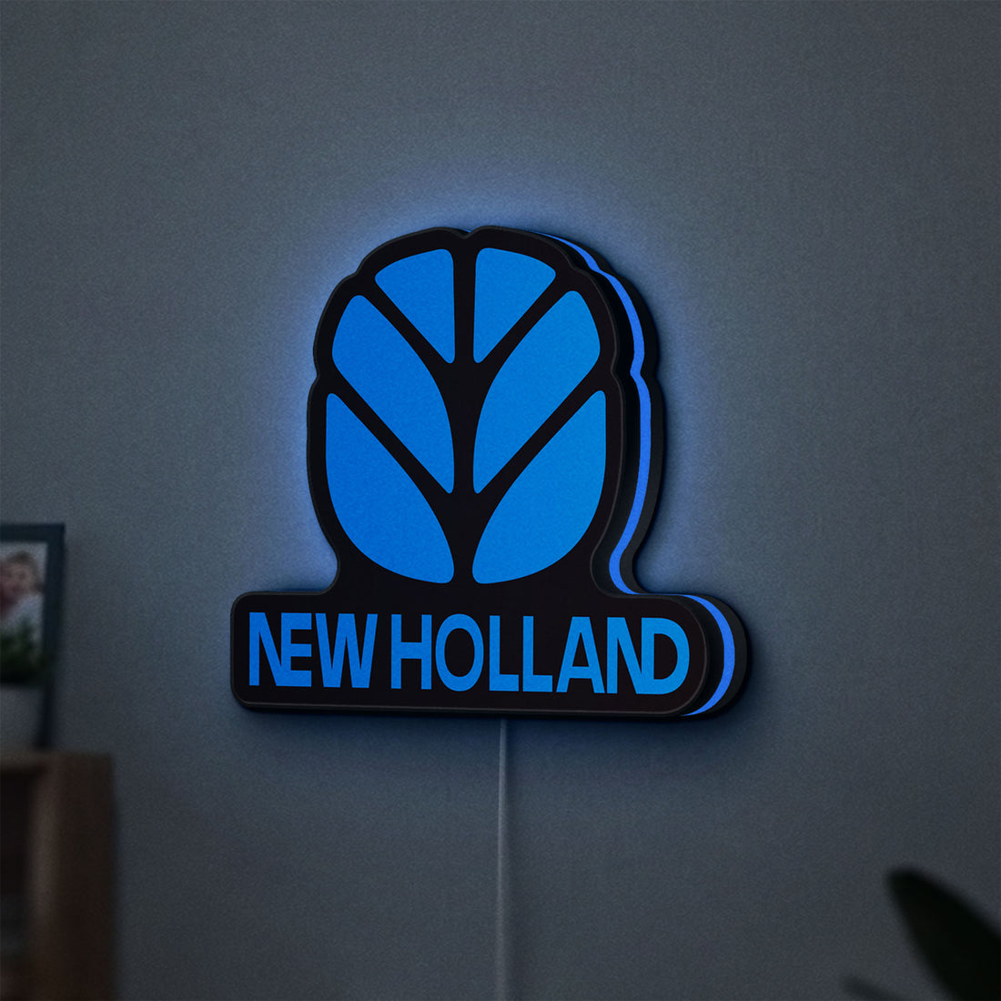 New Holland LED lightbox hanging on a wall with blue glow