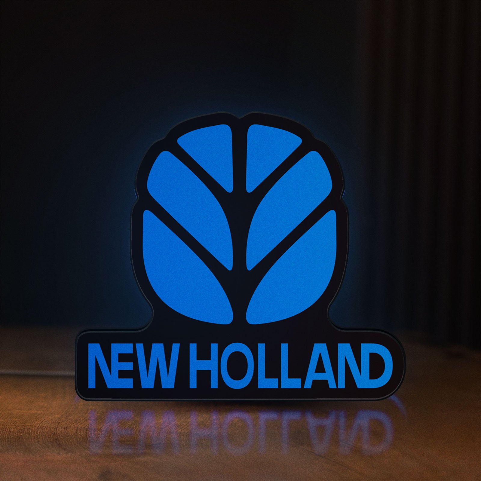 Front view of New Holland LED lightbox sign glowing on a wooden desk