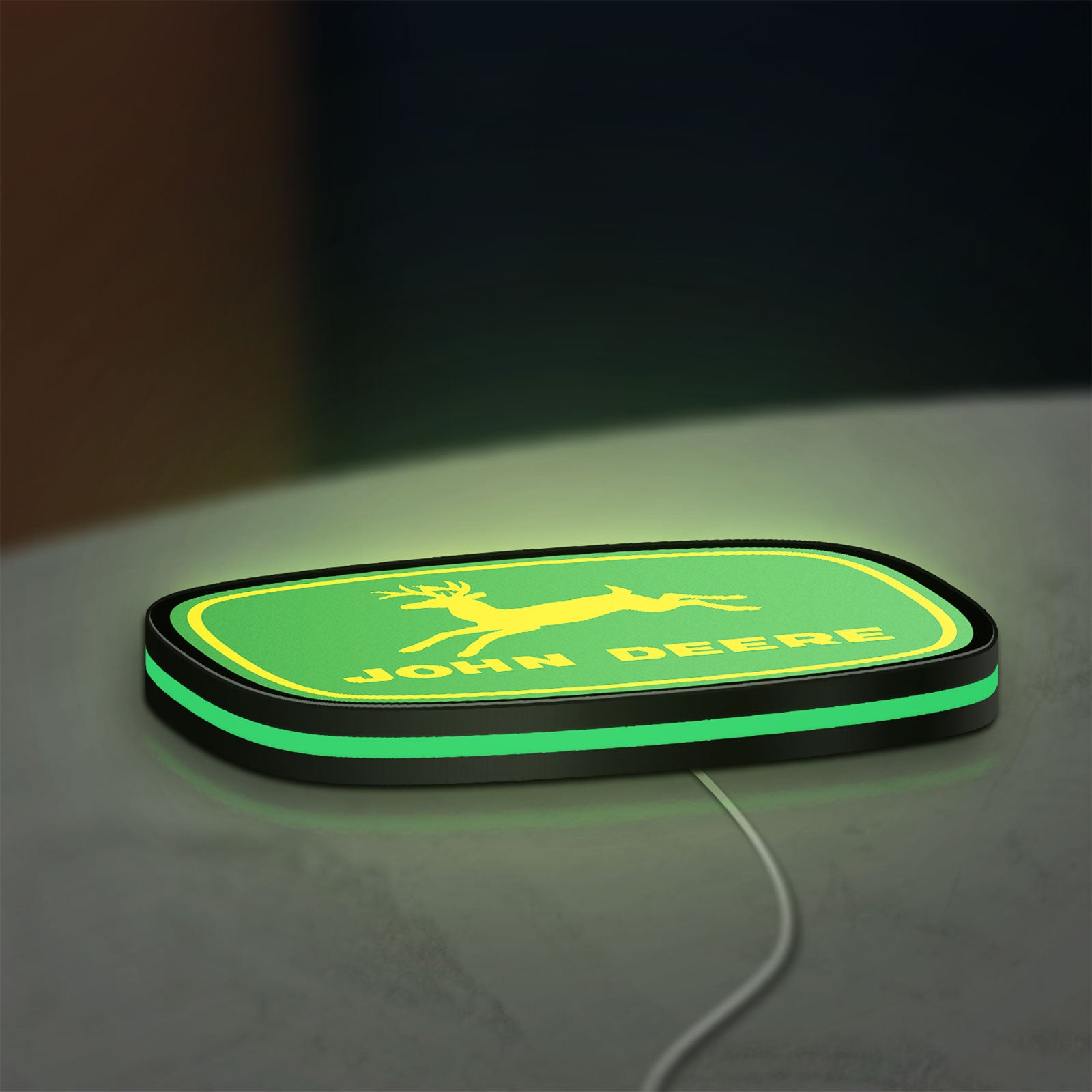 John Deere LED lightbox lying flat on a desk with green glow
