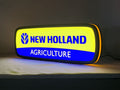 New Holland Agriculture LED Sign (50cm) - Illuminated angled view standing, perfect for garage and man cave decor