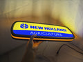 50cm New Holland Agriculture Glowing Wall Art - Illuminated handheld size reference, perfect for garage and man cave decor