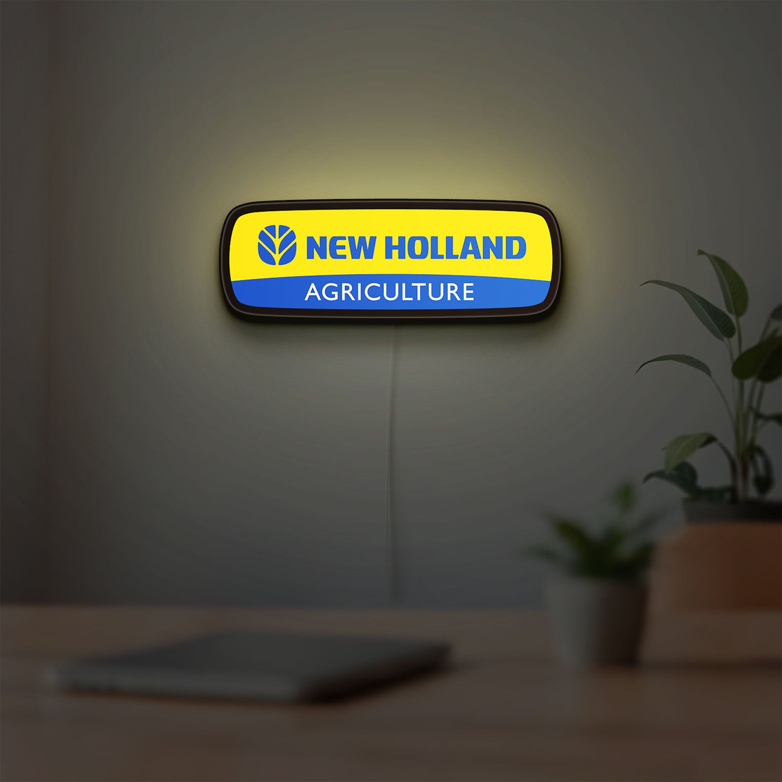 New Holland Agriculture LED lightbox hanging on a room wall with soft yellow light