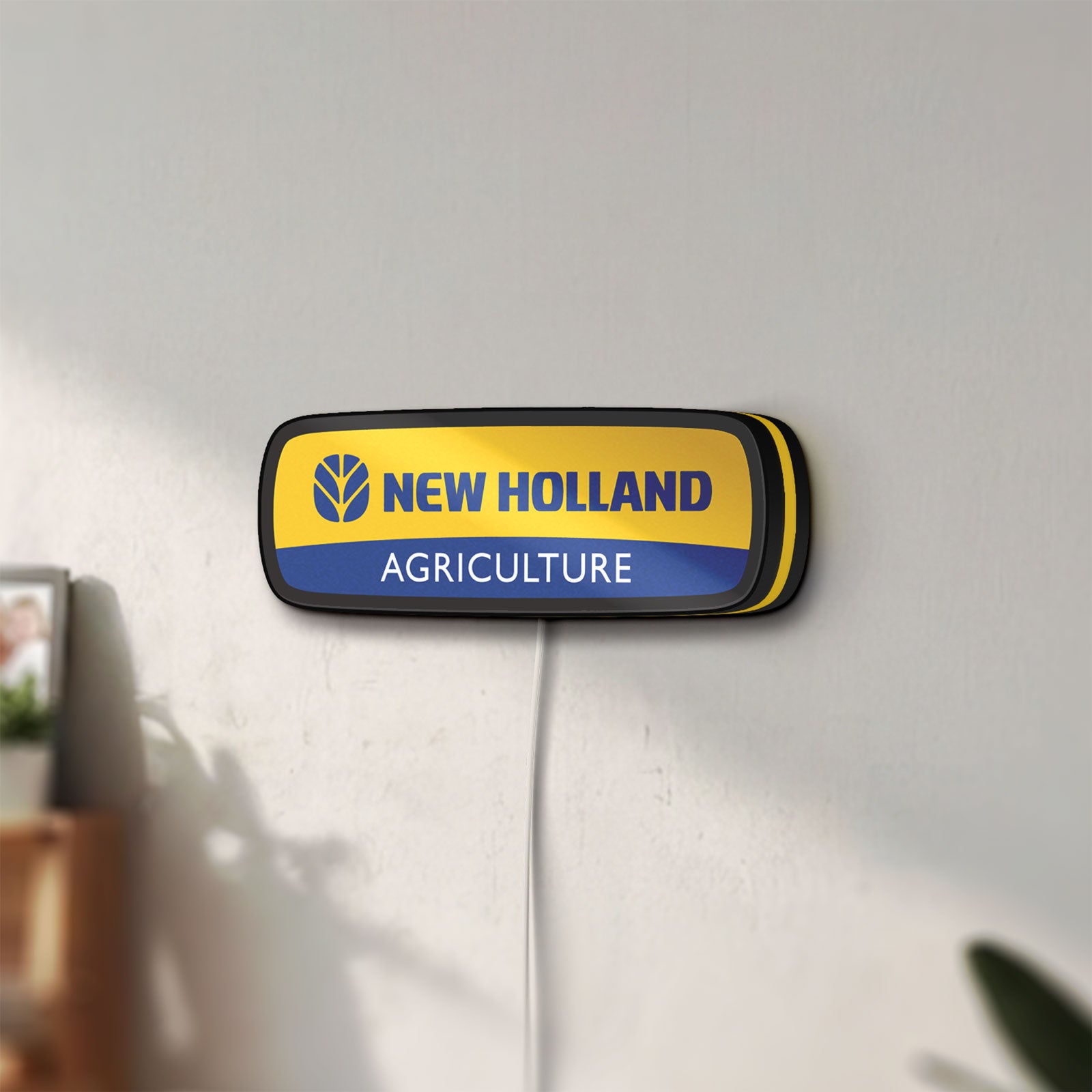 Unlit New Holland Agriculture LED lightbox mounted on a wall in daylight
