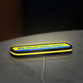 New Holland Agriculture LED lightbox lying flat on a desk with yellow glow