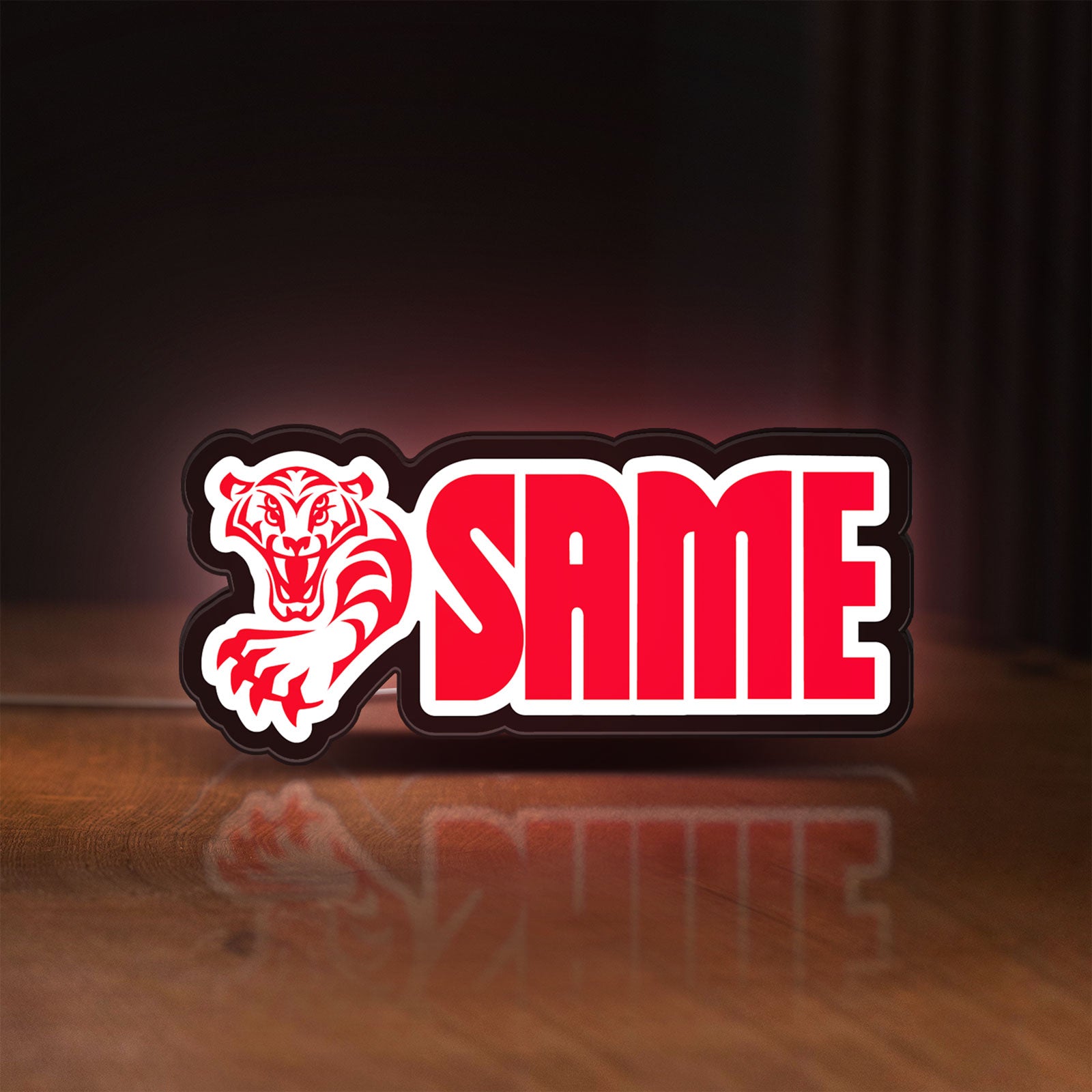 Front view of SAME LED lightbox sign glowing on a wooden desk