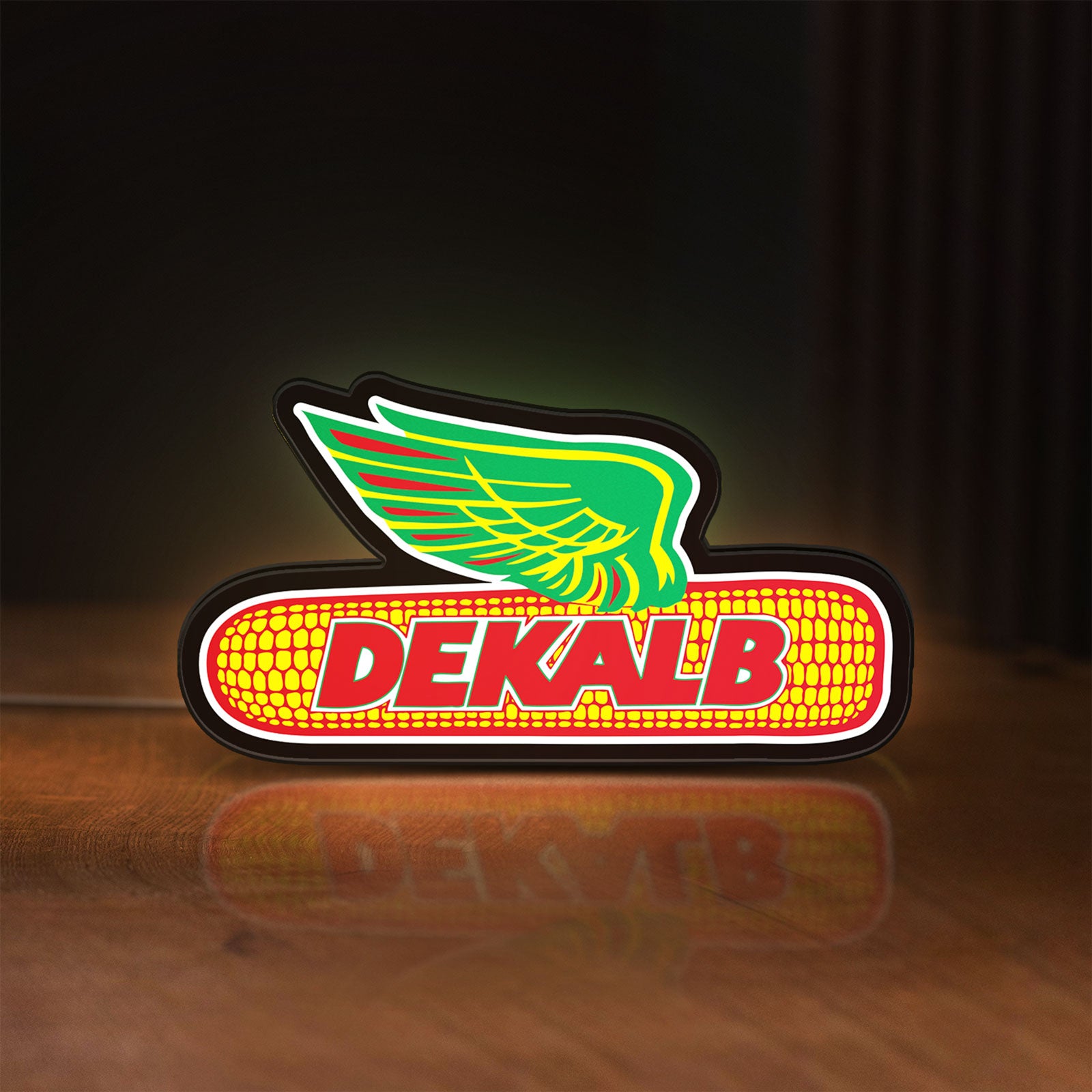 Front view of Dekalb LED lightbox sign glowing on a wooden desk