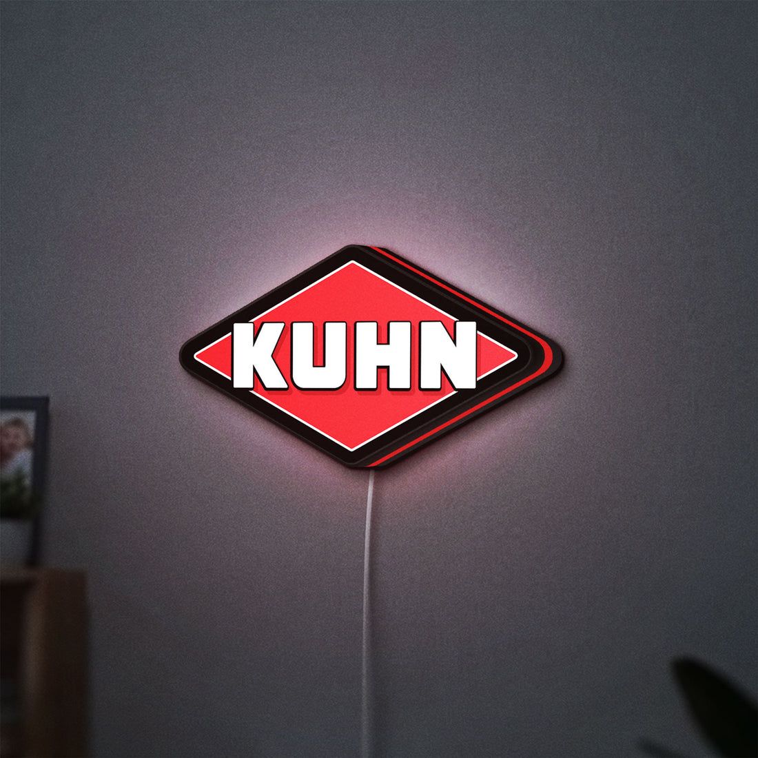 Kuhn LED lightbox hanging on a wall with red glow