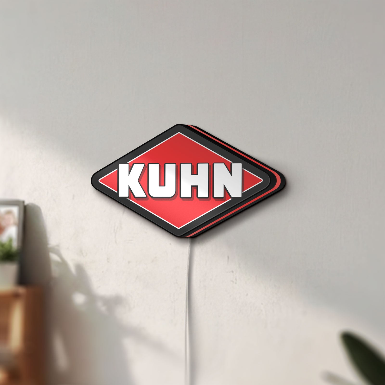 Unlit Kuhn LED lightbox mounted on a wall in daylight