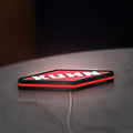 Kuhn LED lightbox lying flat on a desk with red glow