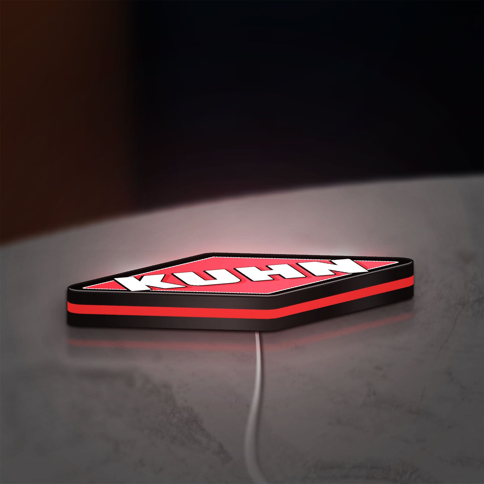Kuhn LED lightbox lying flat on a desk with red glow