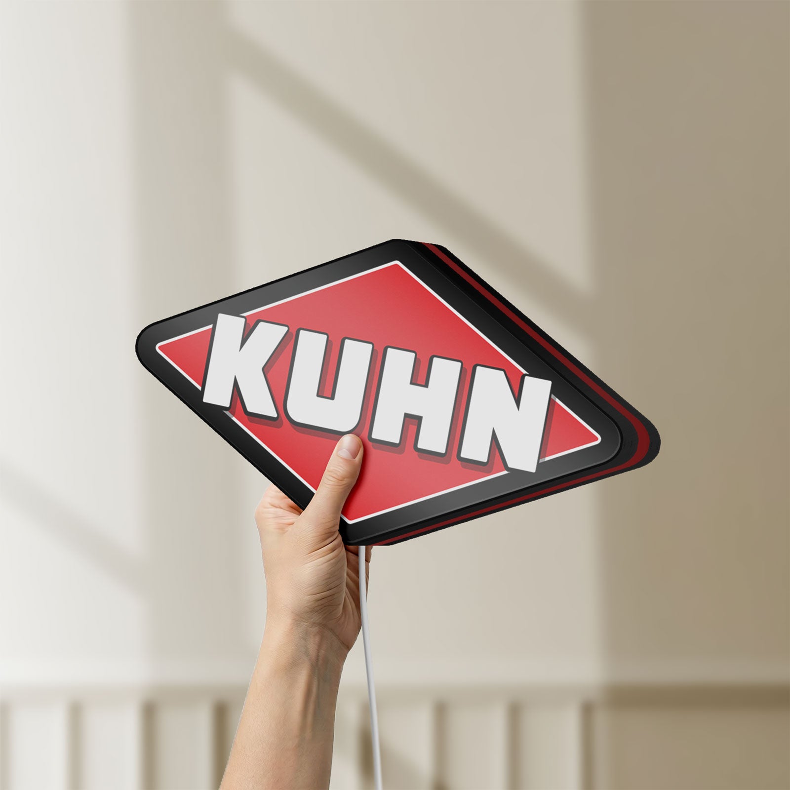 Unlit Kuhn LED lightbox held by hand to show size and details