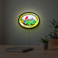Baru Black Mountain Cafe LED lightbox hanging on a room wall with soft yellow light