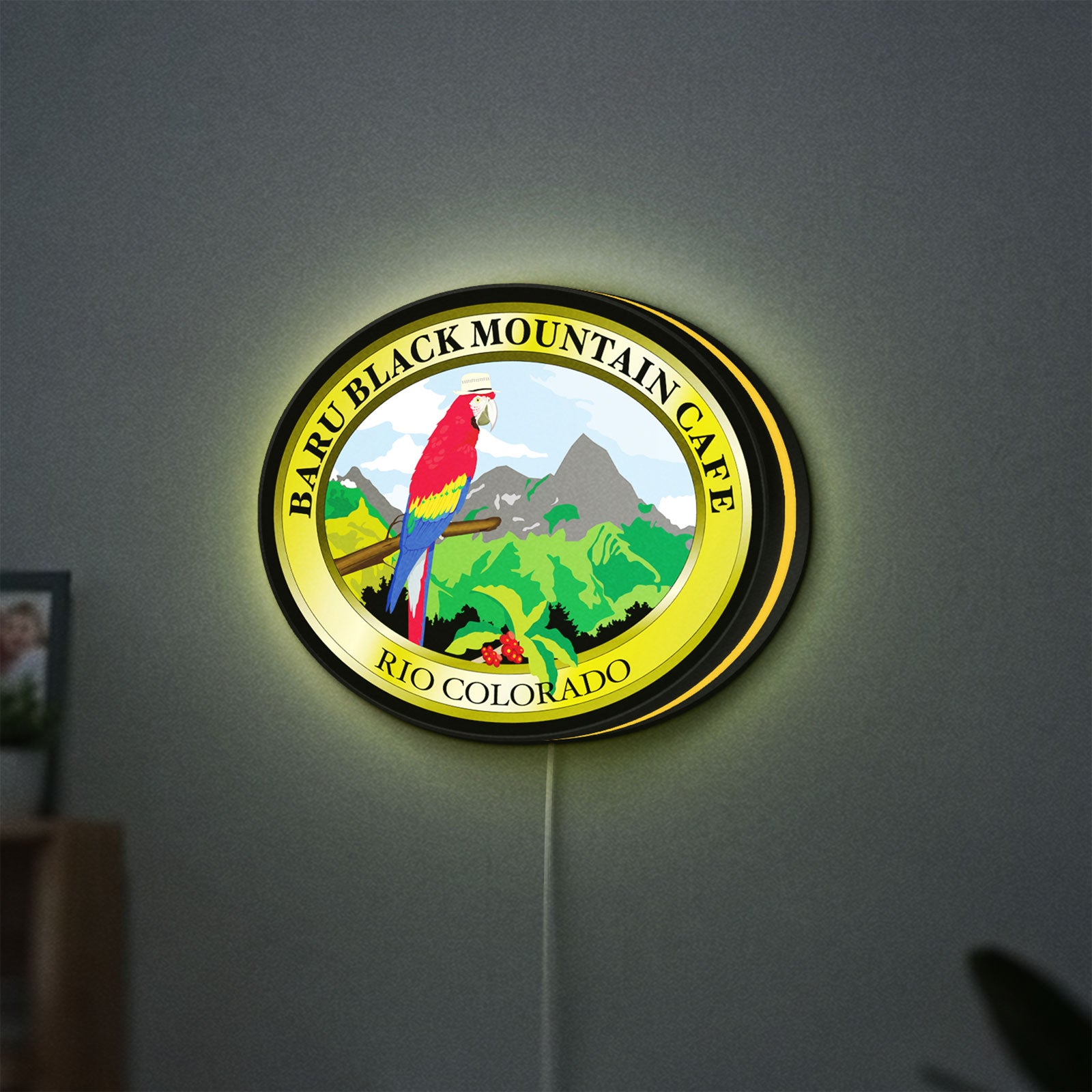 Baru Black Mountain Cafe LED lightbox hanging on a wall with yellow glow