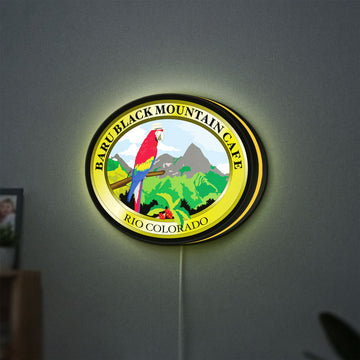 Baru Black Mountain Cafe LED lightbox hanging on a wall with yellow glow
