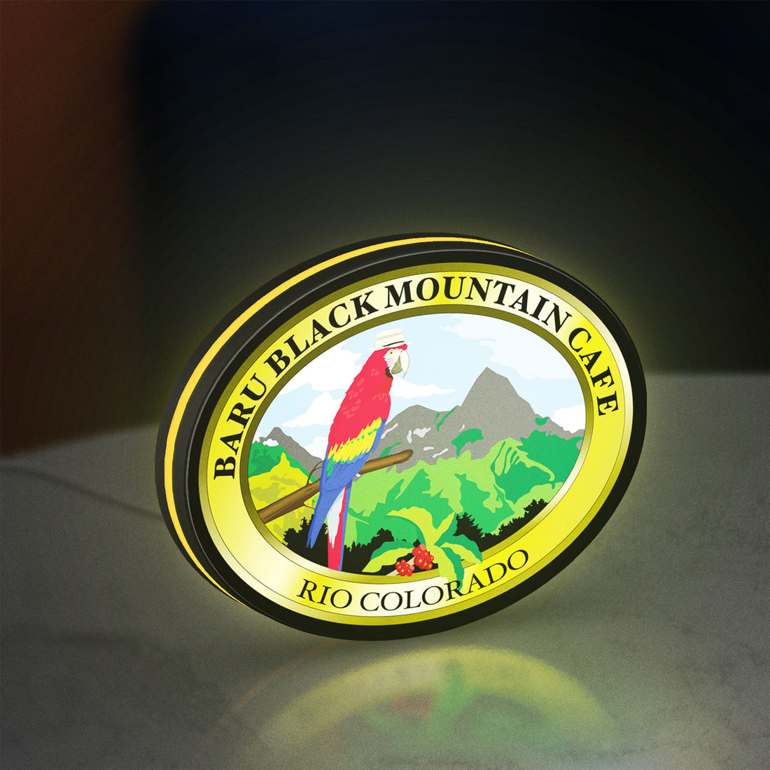 Baru Black Mountain Cafe LED lightbox hanging on a wall with yellow glow