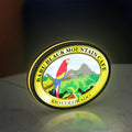 Baru Black Mountain Cafe LED lightbox standing on a desk from an angled side view with yellow glow