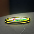 Baru Black Mountain Cafe LED lightbox lying flat on a desk with yellow glow