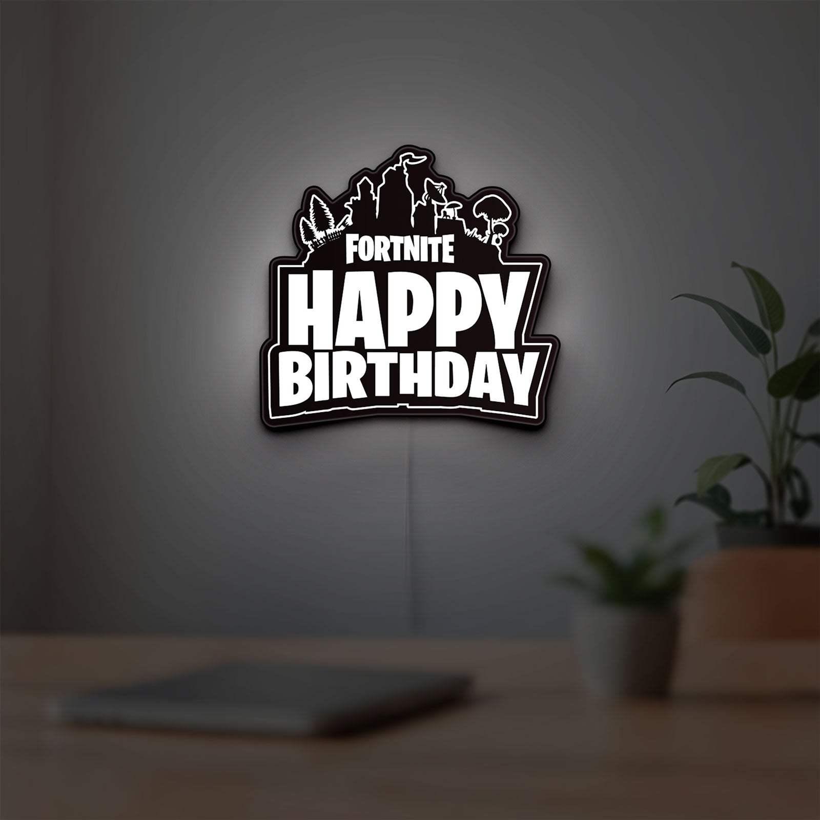 Fortnite LED lightbox hanging on a room wall with soft white light
