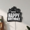 Unlit Fortnite LED lightbox mounted on a wall in daylight