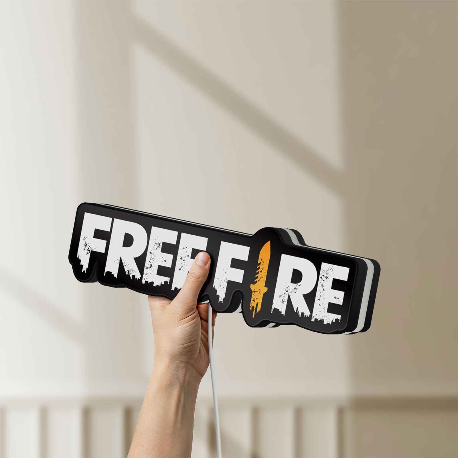 Unlit Free Fire LED lightbox held by hand to show size and details