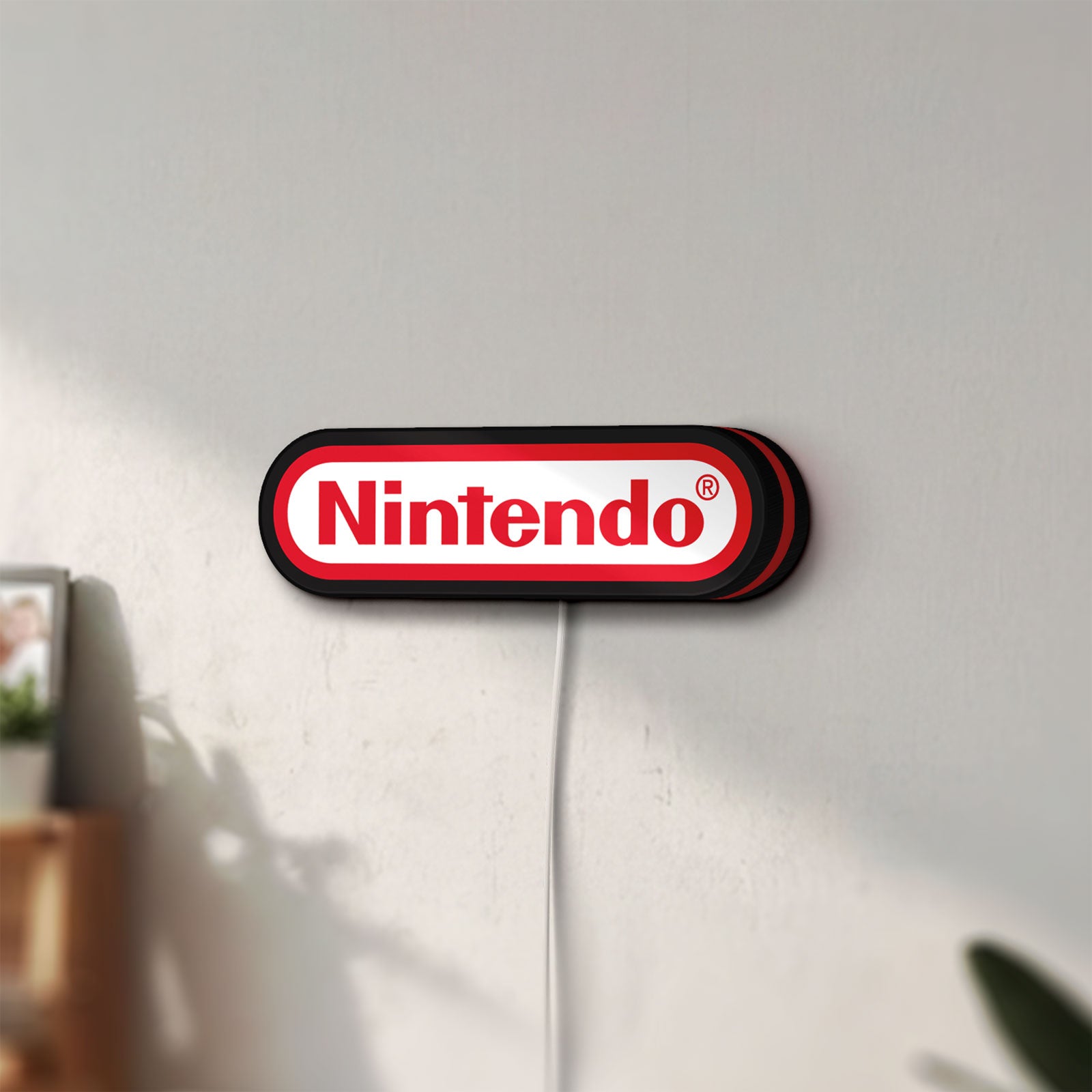 Unlit Nintendo LED lightbox mounted on a wall in daylight